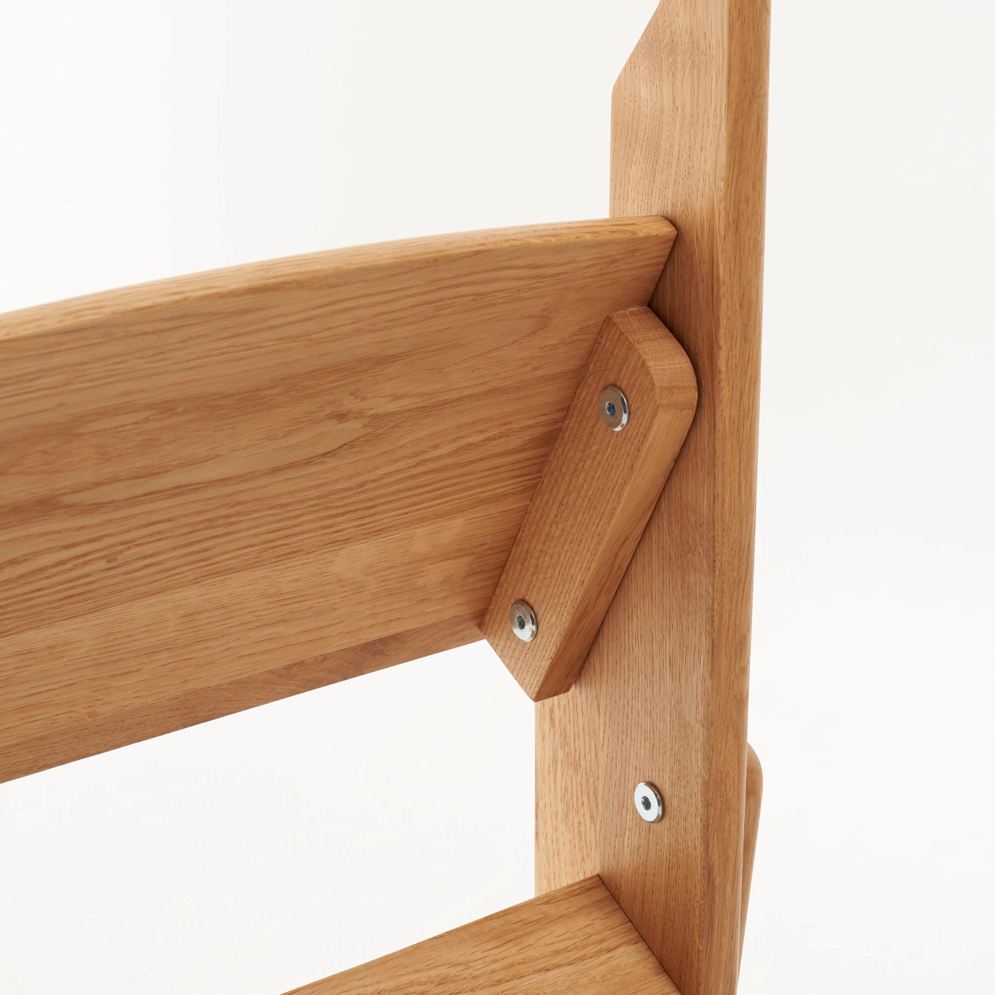 Joinery detail with pegs and screws on solid oak step ladder
