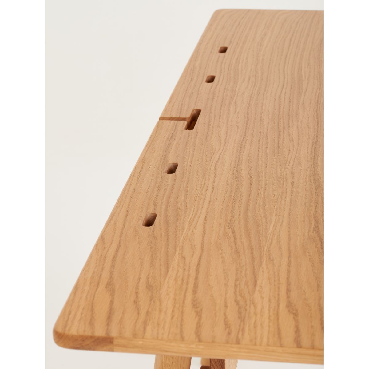 Hidden cable compartment in Scandinavian oak desk for cords and power outlets