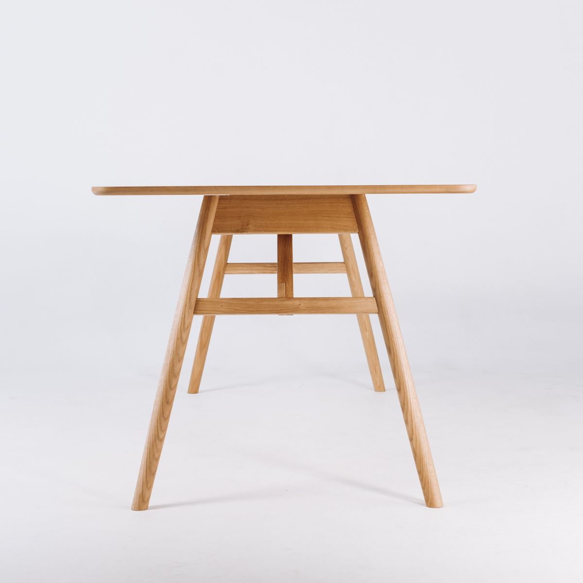 Light oak dining table with solid oak legs and minimalist Scandinavian design
