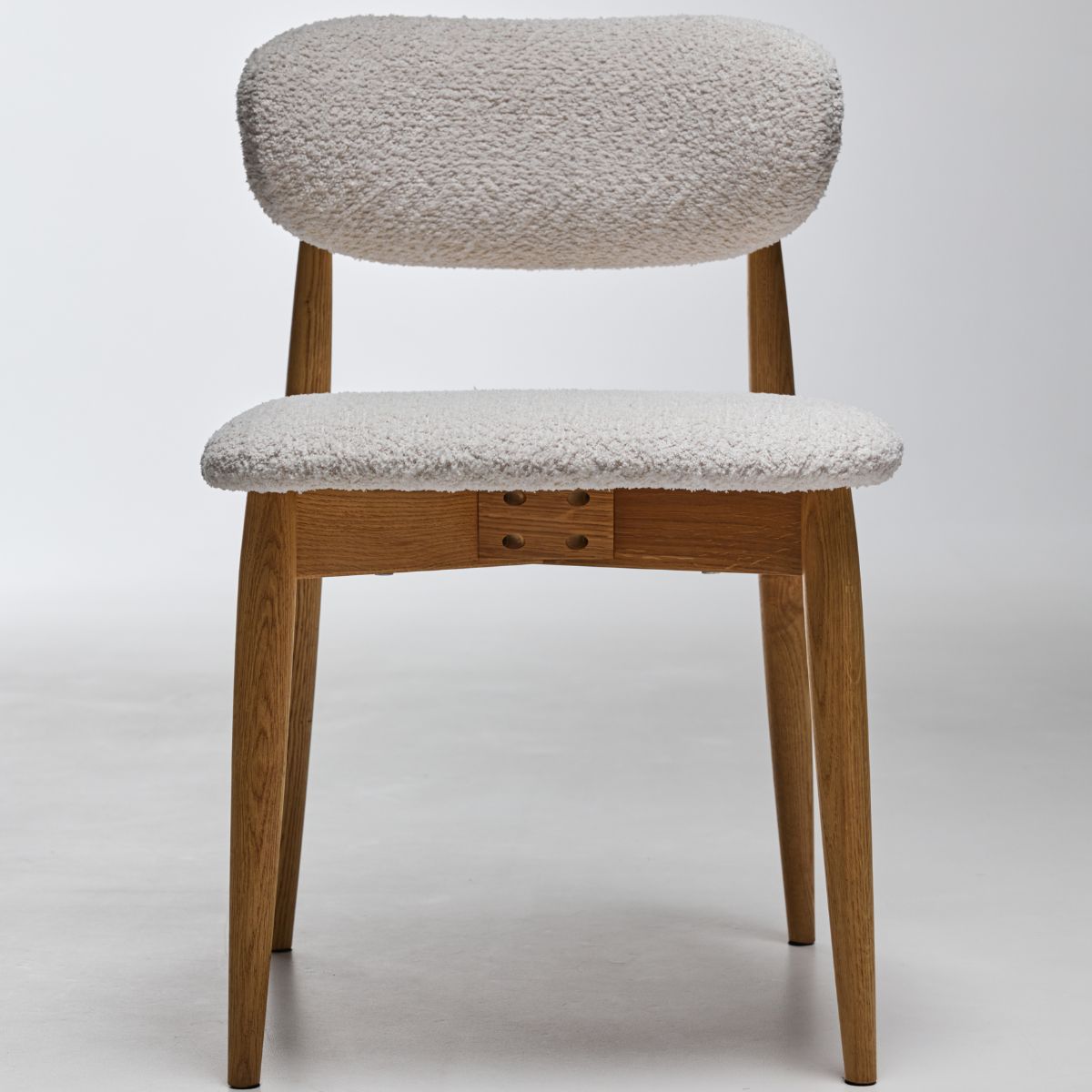 Wooden dining chair with upholstered back styled in home interior