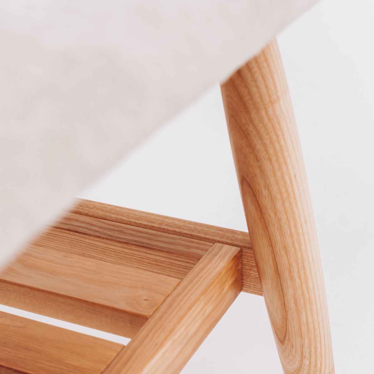 handmade oak bench with upholstered light fabric seat